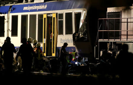 Firefighters and paramedics work at the scene where two trains collided in Aichach near Augsburg, Germany May 8, 2018. REUTERS/Michael Dalder