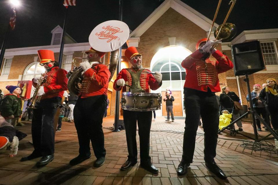 Members of the SupaFun Band, from left, Johnny Bauchman, Rob Maccabee, Johnny Polansky and Will Horner perform as toy soldiers during the tree-lighting ceremony in uptown Westerville on Dec. 4.