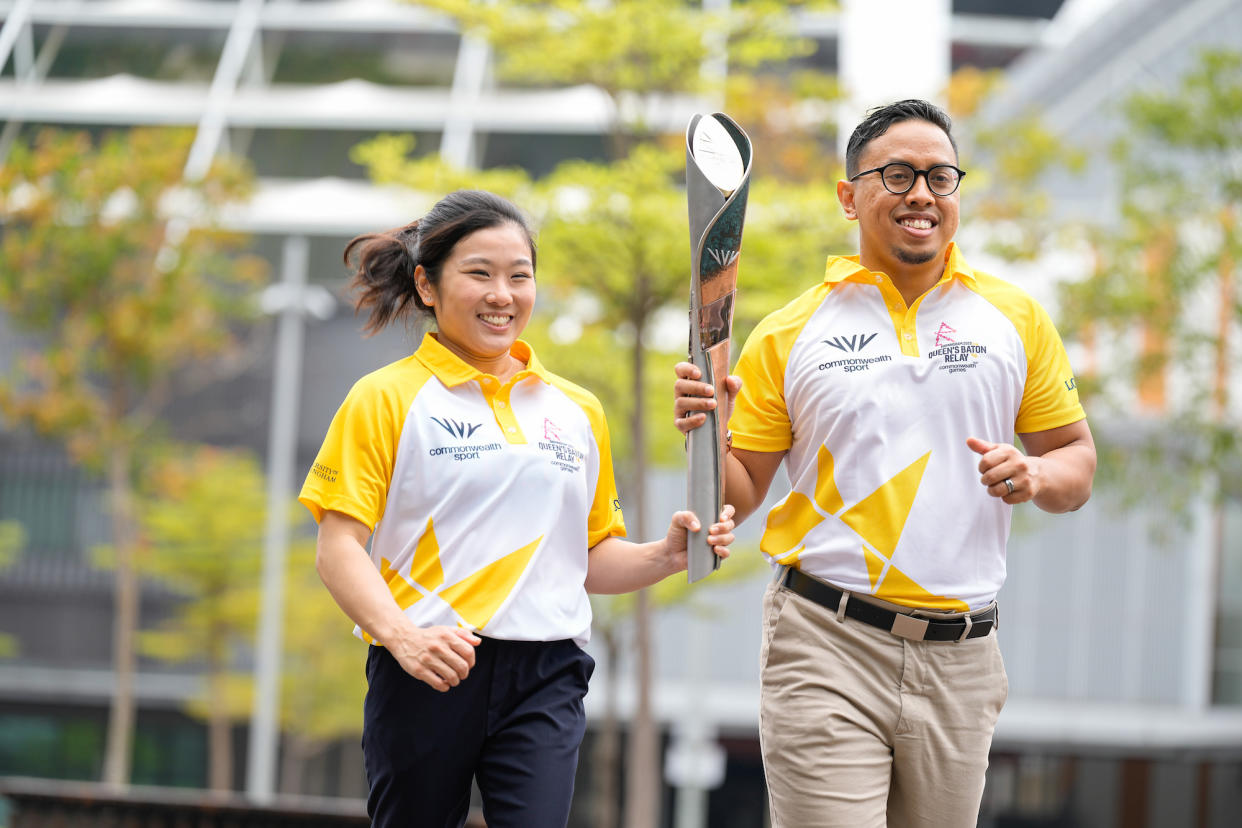 Team Singapore's chefs de mission Lim Heem Wei (left) and Amirudin Jamal with the Queen's Baton of the 2022 Commonwealth Games. (PHOTO: Kong Chong Yew/Commonwealth Games Singapore)