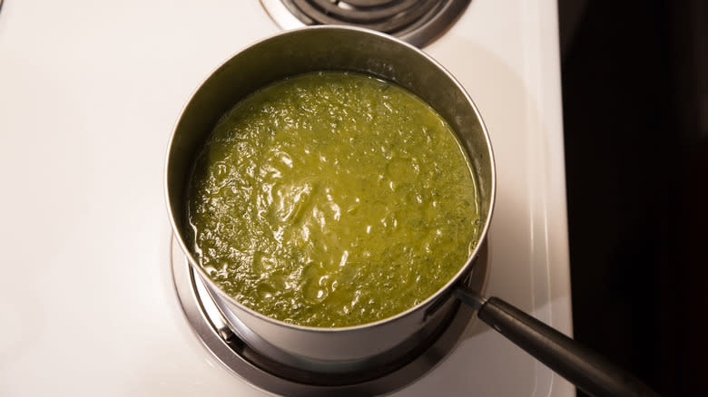 blended green soup in saucepan 