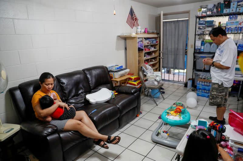 FILE PHOTO: Judith and Jose Ramirez feed their youngest daughter inside their home in Honolulu