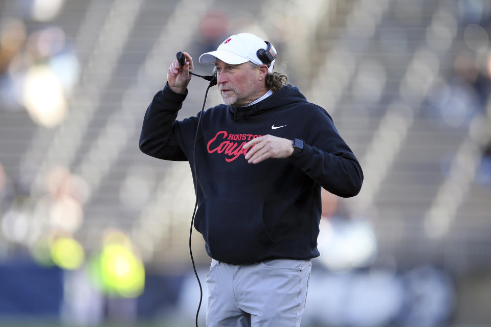 Houston head coach Dana Holgorsen walks onto the field during the first half of an NCAA football game against Connecticut, Saturday, Nov. 27, 2021, in East Hartford, Conn. (AP Photo/Stew Milne)