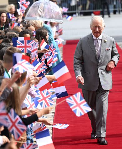 <p>Samir Hussein/WireImage</p> King Charles greets schoolchildren in Bordeaux, France on Sept. 22