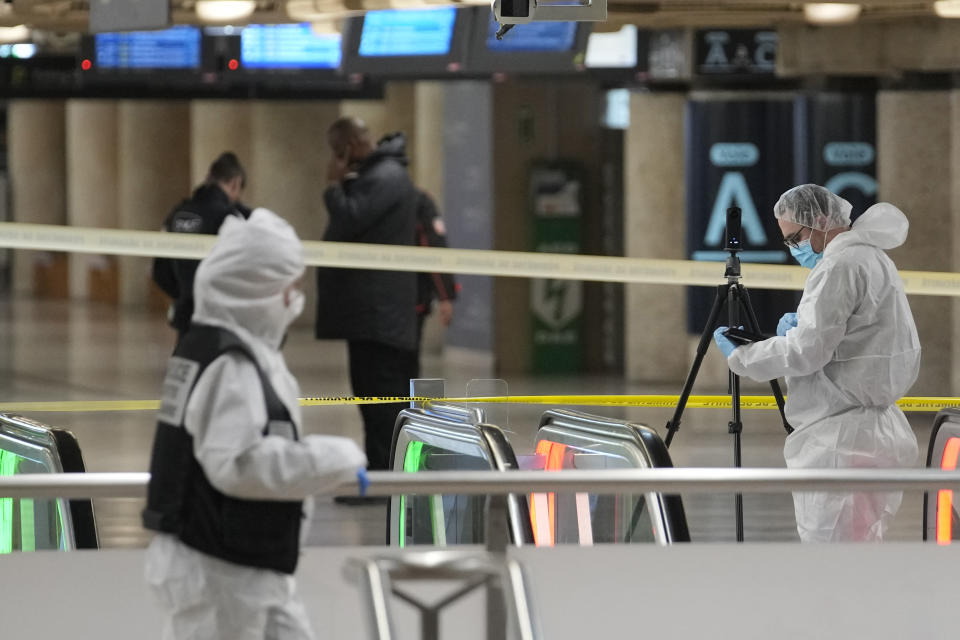 Police investigators work inside the Gare de Lyon station after an attack, Saturday, Feb. 3, 2024 in Paris. A man seemingly armed with a knife and a hammer injured three people Saturday in an early-morning attack at the major Gare de Lyon train station in Paris, another nerve-rattling security incident in the Olympic host city before the Summer Games open in six months. (AP Photo/Christophe Ena)