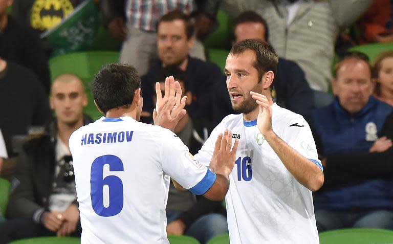 Uzbekistan's Vokhid Shodiev (R) celebrates with teammate Bakhodir Nasimov after scoring during the Asian Cup match against Saudi Arabia in Melbourne on January 18, 2015