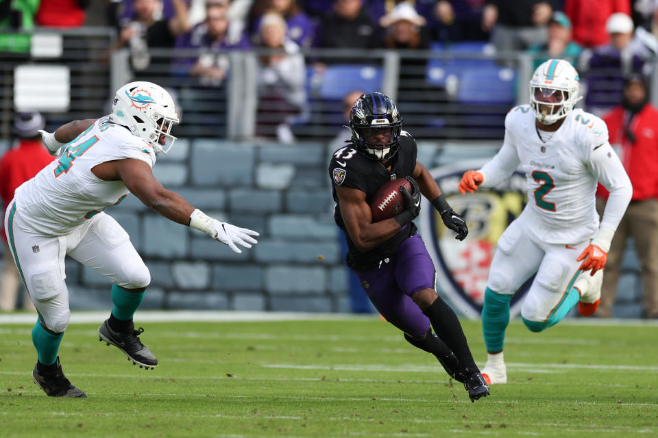 BALTIMORE, MARYLAND – DECEMBER 31: Justice Hill #43 of the Baltimore Ravens carries the ball against the Miami Dolphins during the first half of the game at M&T Bank Stadium on December 31, 2023 in Baltimore, Maryland. (Photo by Todd Olszewski/Getty Images)