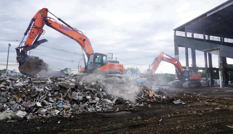 The C. Carney demolition crew organizes and clears debris on Friday, July 14, 2023, to make greater access for dump trucks to arrive and take it away for disposal after the grandstands at the Brockton Fairgrounds was scheduled to come down on Monday, July 17, 2023.