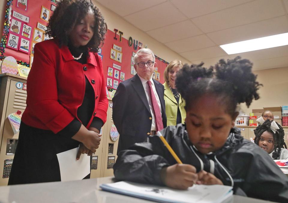 Interim Akron Public Schools Superintendent Mary Outley, Gov. Mike DeWine and First Lady Fran DeWine observe a second grader and her classmates during a reading lesson at Helen Arnold Community Learning Center Tuesday in Akron.