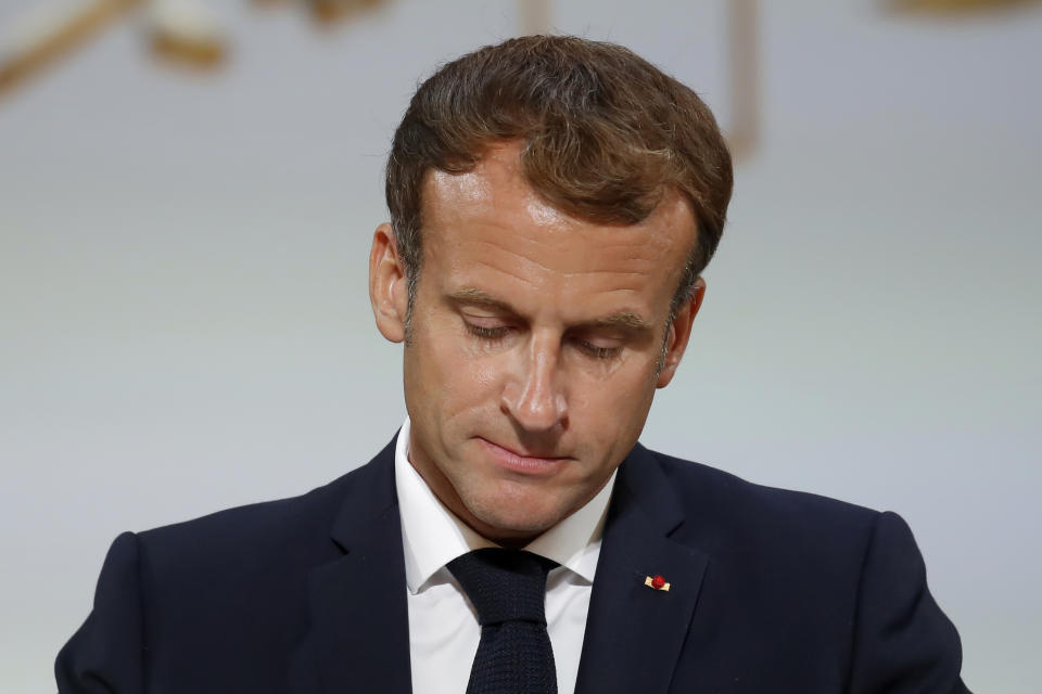 French President Emmanuel Macron pauses as he delivers a speech during a meeting in memory of the Algerians who fought alongside French colonial forces in Algeria's war, known as Harkis, at the Elysee Palace in Paris, Monday, Sept. 20, 2021. Macron's speech is the latest step in his efforts to reconcile France with its dark colonial past, especially in Algeria. (Gonzalo Fuentes/Pool Photo via AP)