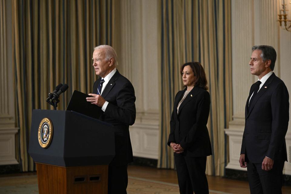 US President Joe Biden, with Vice President Kamala Harris (C) and Secretary of State Antony Blinken (R), speaks about the attacks on Israel, in the State Dining Room of the White Houses in Washington, DC, on October 10, 2023.