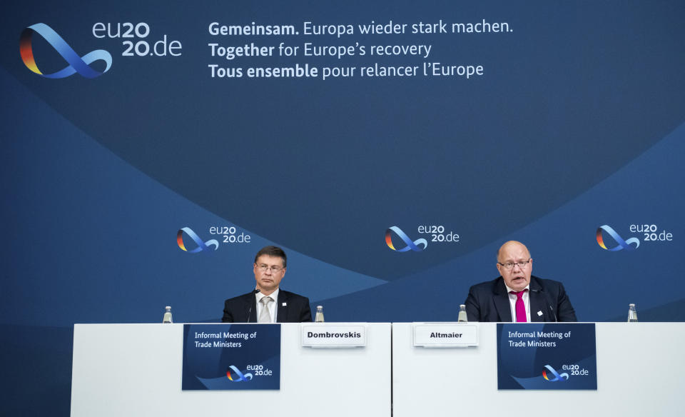 Peter Altmaier right, Federal Minister of Economics and Energy, and Valdis Dombrovskis, Vice-President of the EU Commission, speak at a press conference in Berlin, Germany, following the informal talks of the EU Trade Ministers on Monday, Sept. 21, 2020. (Bernd von Jutrczenka/Pool via AP)