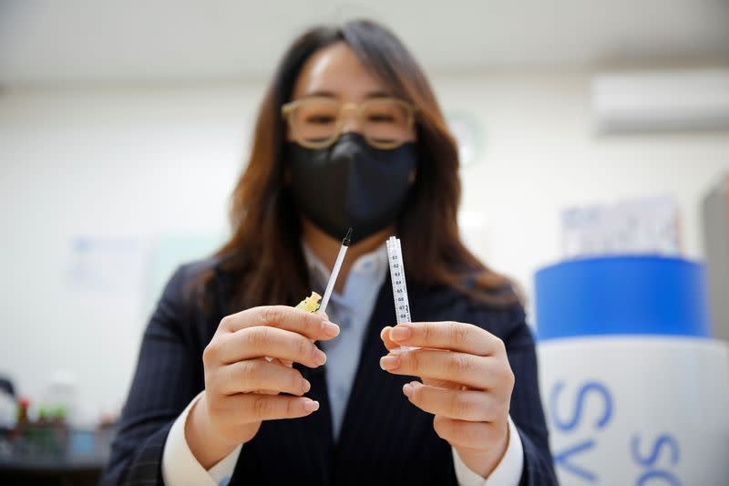 Cho Mi-heui, vice president of PoongLim Pharmatech Inc. showcases a sample of a low dead space (LDS) syringe at a company office in Gunsan