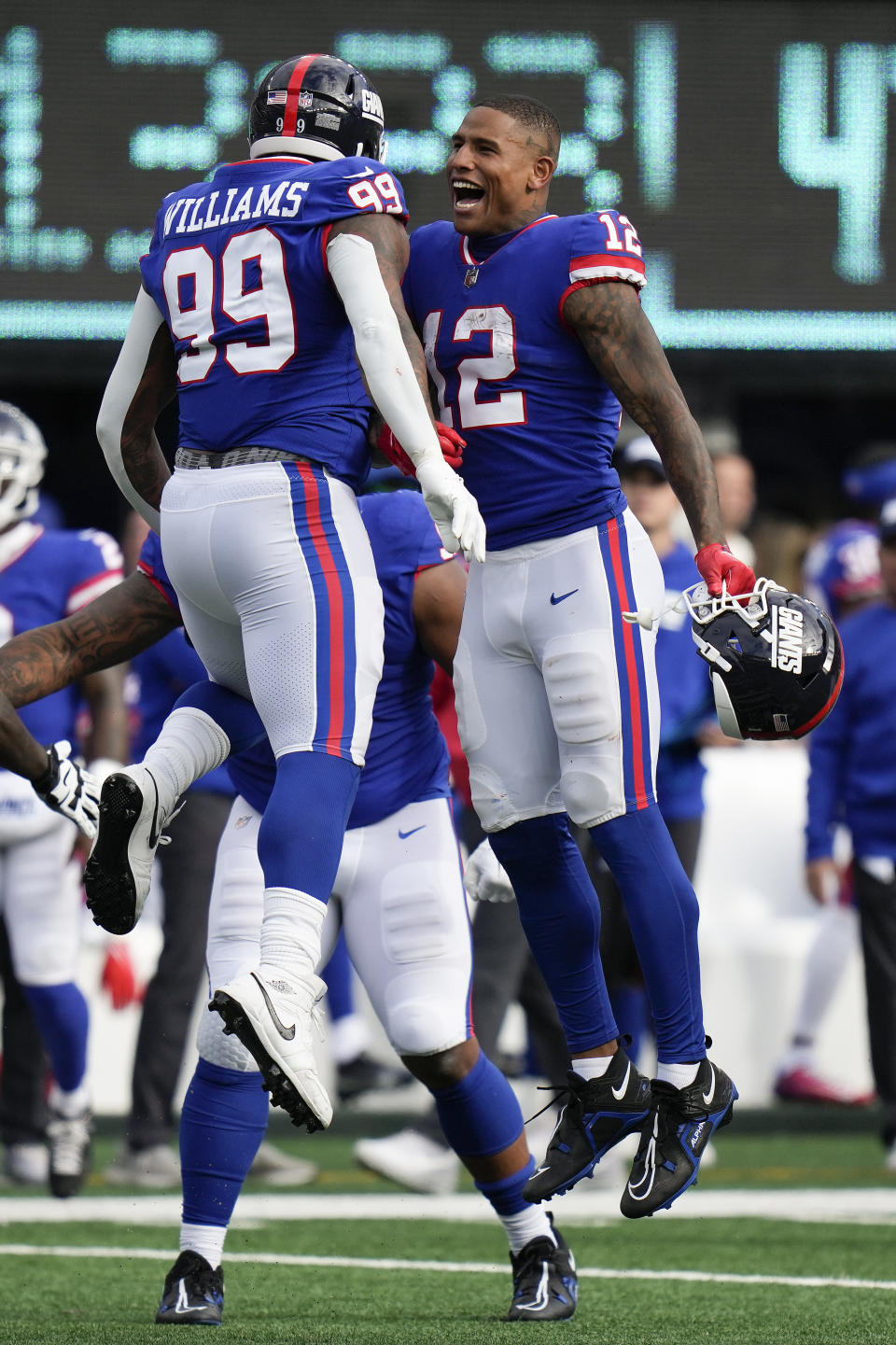 New York Giants defensive end Leonard Williams (99) celebrates with tight end Darren Waller (12) after blocking a field goal attempt by the Washington Commanders during the fourth quarter of an NFL football game, Sunday, Oct. 22, 2023, in East Rutherford, N.J. (AP Photo/Seth Wenig)