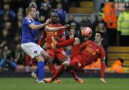 Oldham Athletic's Adam Rooney (L) challenges Liverpool's Luis Alberto during their FA Cup third round soccer match at Anfield in Liverpool January 5, 2014. REUTERS/Phil Noble (BRITAIN - Tags: SPORT SOCCER)