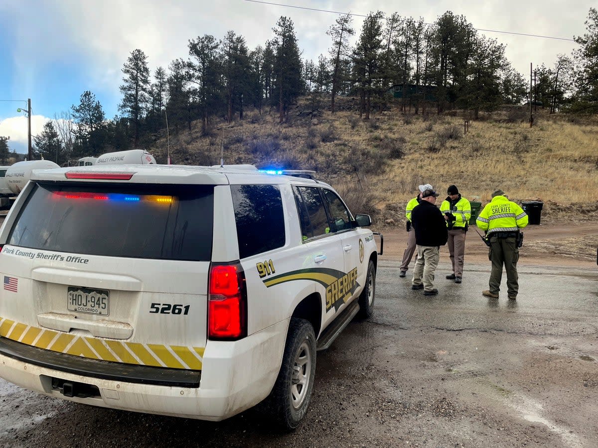 Law enforcement on the scene where Austin Lyle’s car was located, with his body found close by  (Copyright 2023 The Associated Press. All rights reserved.)