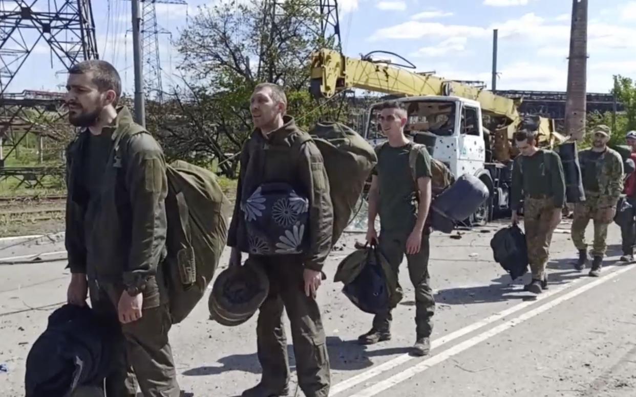 In this photo taken from video released by the Russian Defense Ministry on Friday, Ukrainian servicemen are pictured as they leave the besieged Azovstal steel plant in Mariupol. (Russian Defense Ministry Press Service via AP)