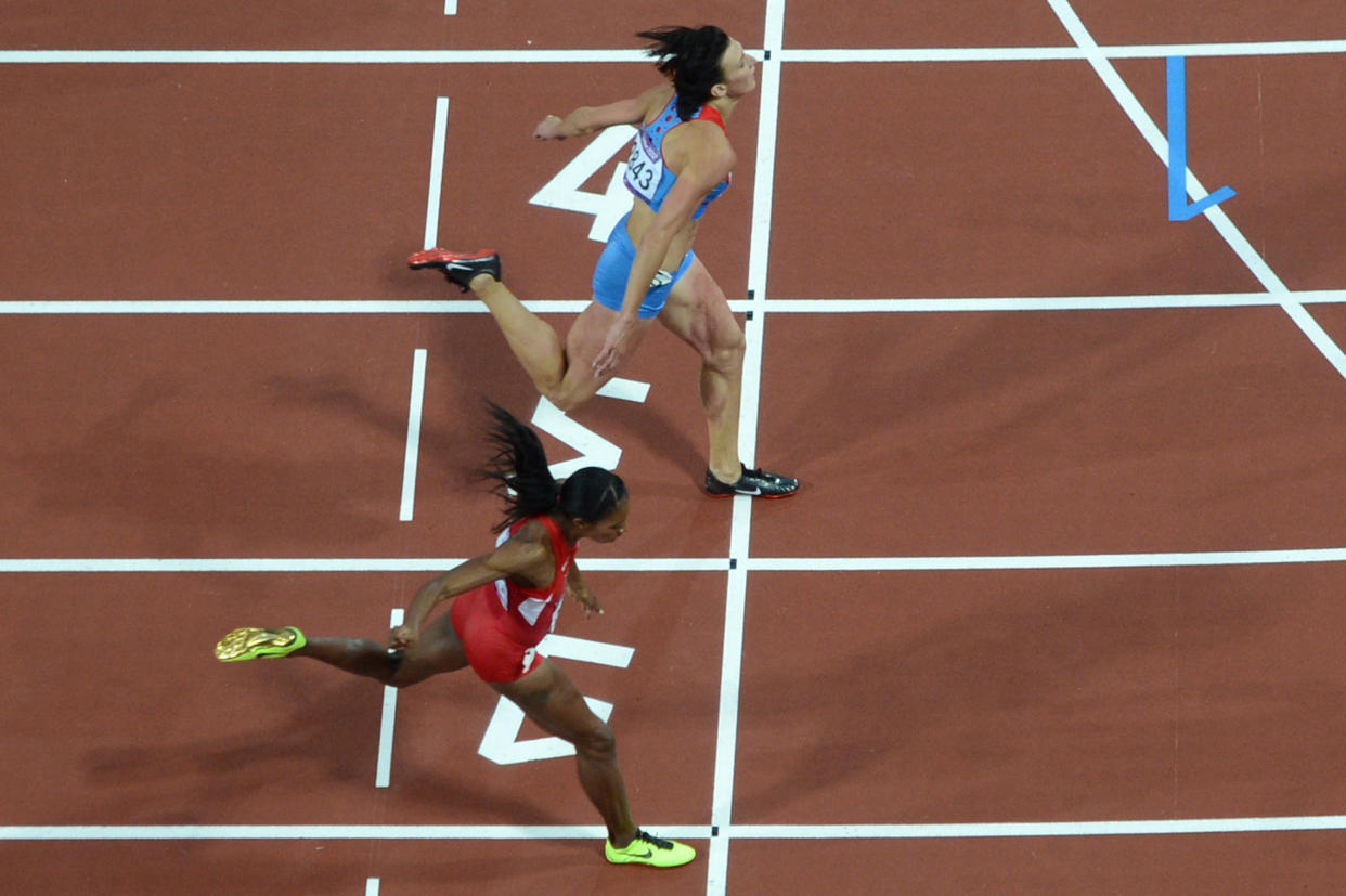 -PICTURE TAKEN WITH A ROBOTIC CAMERA-
Russia's Natalya Antyukh (Top) wins the women's 400m hurdles final ahead of US' Lashinda Demus at the athletics event of the London 2012 Olympic Games on August 8, 2012 in London. AFP PHOTO / FRANCOIS XAVIER MARIT        (Photo credit should read FRANCOIS XAVIER MARIT/AFP/GettyImages)