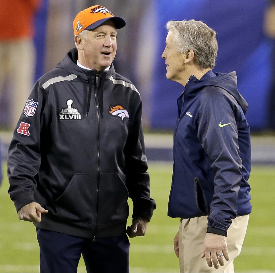 Denver Broncos head coach John Fox, left, greets Seattle Seahawks head coach Pete Carroll before the NFL Super Bowl XLVIII football game Sunday, Feb. 2, 2014, in East Rutherford, N.J. (AP Photo/Chris O'Meara)