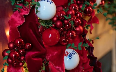 The Be Best logo can be found in a decorative garland - Credit: NICHOLAS KAMM/ AFP