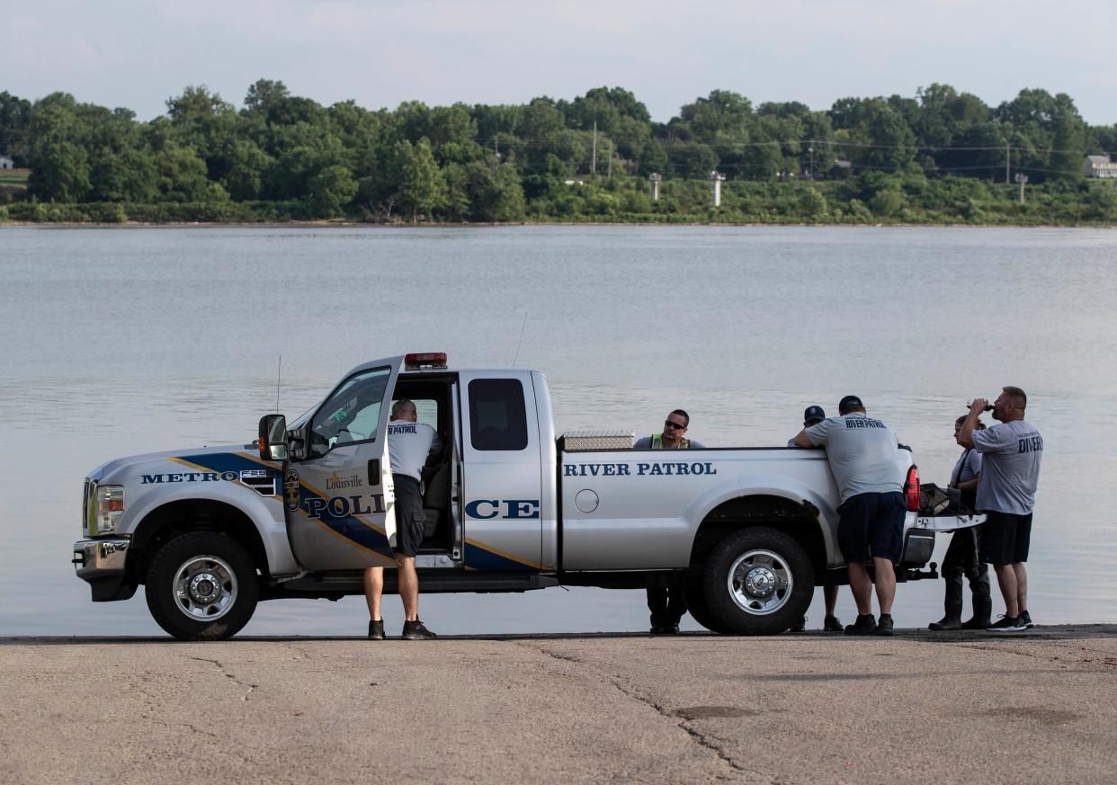 Louisville Metro Police on the scene at the Cox' Park boat ramp where a man, whose car was on fire, drove it into the Ohio River. The man was later rescued by a passing barge and is at hospital with non-life threatening injuries. June 6, 2022