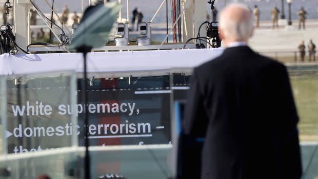 Biden faces a monitor with the word "white supremacy" during his inaugural speech