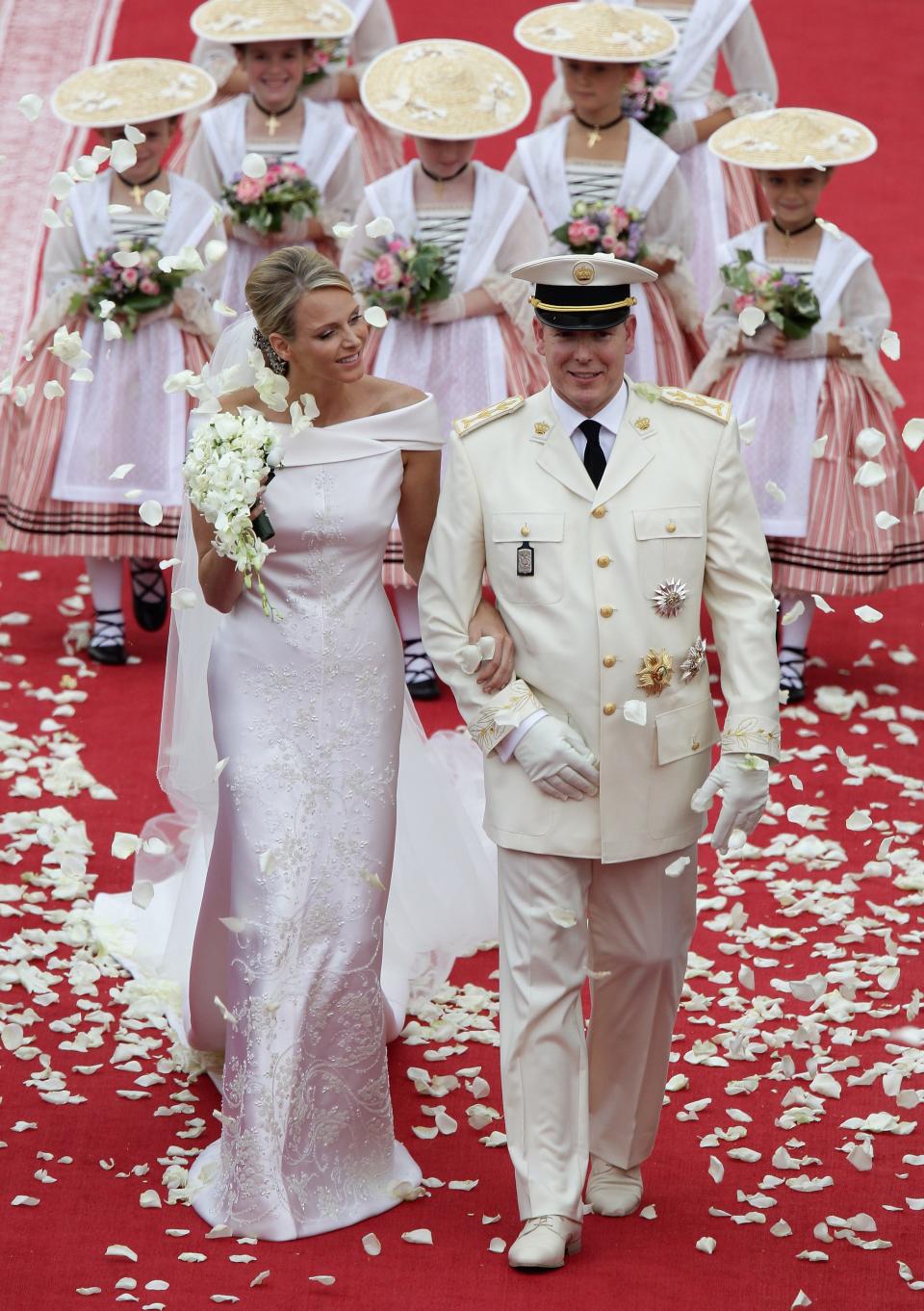 Princess Charlene and Prince Albert smile as they leave the palace after their religious wedding ceremony on July 2, 2011, in Monaco.