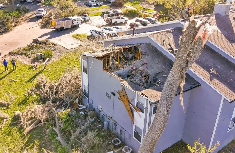 Teams were busy removing trees and debris on Sunday at the Saddleworth Green apartments in southwest Ocala.