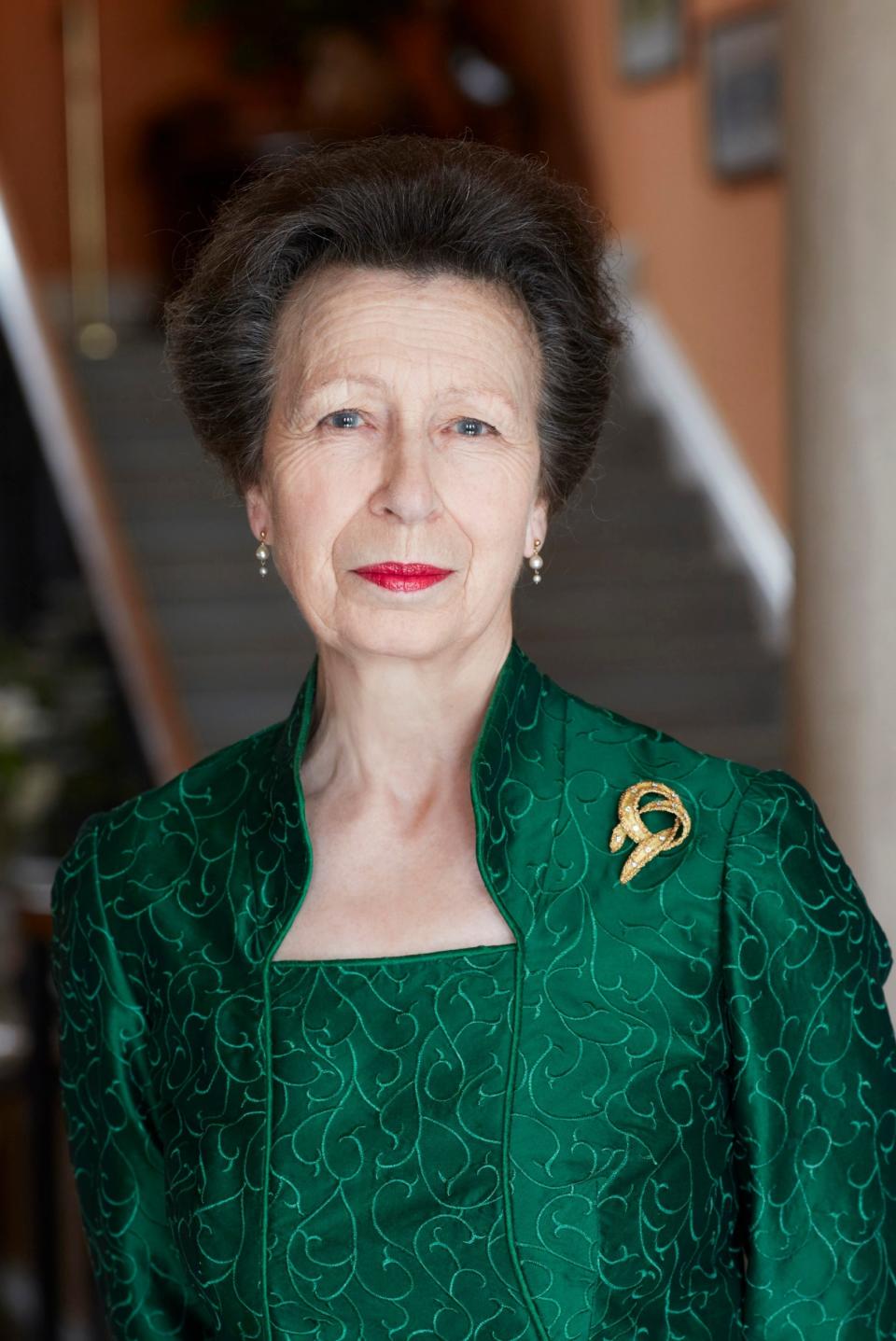 Anne wears a Sue Palmer emerald green dress as she smiles for the camera (Camera Press via Getty Images)