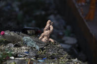 A discarded doll sits atop debris floating in the Pinheiros River in Sao Paulo, Brazil, Thursday, Oct. 22, 2020. Affected by domestic sewage and solid wastes discharges for years, Sao Paulo's state government is again trying to clean the Pinheiros River, considered one of the most polluted in Brazil. (AP Photo/Andre Penner)