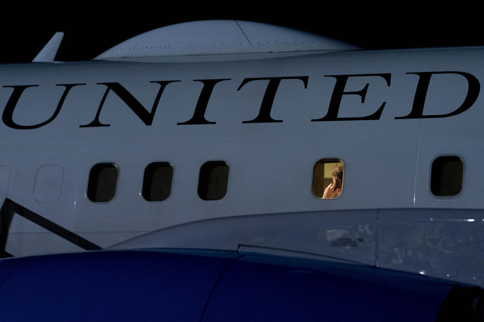 U.S. Secretary of State Antony Blinken speaks on the phone on his plane as he arrives at Lanseria International Airport in Johannesburg, South Africa, Sunday, Aug. 7, 2022. Blinken is on a ten day trip to Cambodia, Philippines, South Africa, Congo, and Rwanda. (AP Photo/Andrew Harnik, Pool)