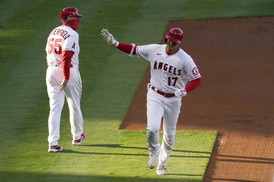 Los Angeles Angels designated hitter Shohei Ohtani (17) runs the bases after hitting a home run during the first inning of a baseball game Tuesday, June 8, 2021, in Los Angeles, Calif. Justin Upton also scored. Third base coach Brian Butterfield (55) is at left. (AP Photo/Ashley Landis)