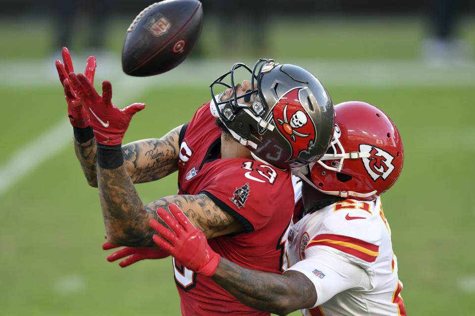 Tampa Bay Buccaneers wide receiver Mike Evans (13) can't hang onto a pass as he is held by Kansas City Chiefs cornerback Bashaud Breeland (21) during the first half of an NFL football game Sunday, Nov. 29, 2020, in Tampa, Fla. (AP Photo/Jason Behnken)