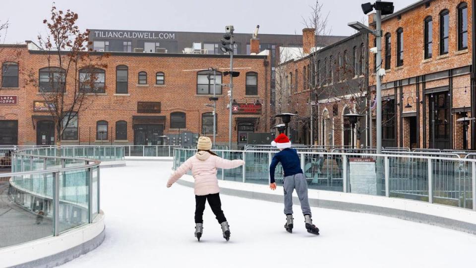 Children ice skate at Indian Creek Plaza. The new, four-story apartment building called Tilian is northwest of the plaza.