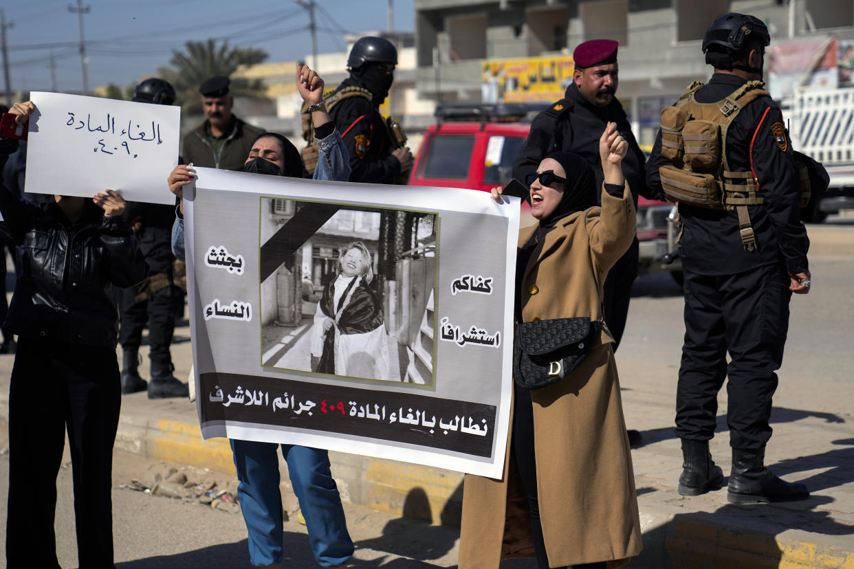 Demonstrators hold a poster with a picture of Tiba Ali, a YouTube star who was recently killed by her father, in Diwaniya, Iraq, Sunday, Feb. 5, 2023. Iraq's Interior Ministry spokesman Saad Maan on Friday announced that Tiba Ali was killed by her father on Jan. 31, who then turned himself into the police. (AP Photo/Hadi Mizban)