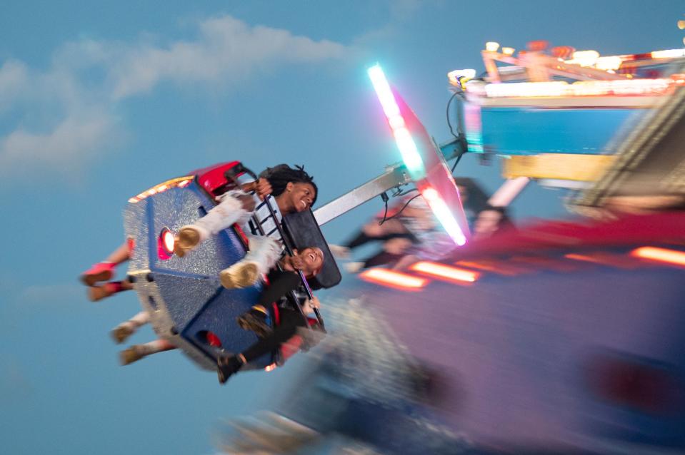 Riders on the Swing Around make their revolutions during Tri-Fest in Henderson, Ky., Friday evening, April 14, 2023.