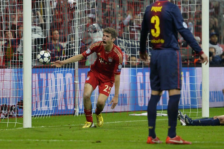 Bayern's Thomas Mueller (L) reacts after scoring the fourth goal during their UEFA Champions league first leg semi-final football match against Barcelona at the Allianz arena in Munich on April 23, 2013. Bayern Munich won 4-0