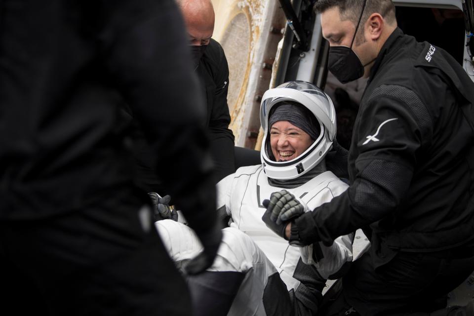 NASA astronaut Megan McArthur is helped out of the SpaceX Dragon Endeavour spacecraft onboard the SpaceX GO Navigator recovery ship after she and three other astronauts anded in the Gulf of Mexico off the coast of Pensacola, Fla., on Monday.