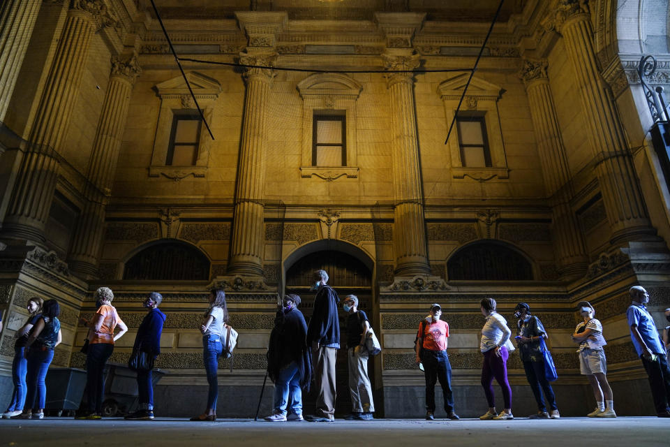 Voters wait in line to make corrections to their ballots for the midterm elections at City Hall in Philadelphia, Monday, Nov. 7, 2022. According to data from AP VoteCast, voters with no religious affiliation supported Democratic candidates and abortion rights by staggering percentages in the 2022 midterm elections. (AP Photo/Matt Rourke)