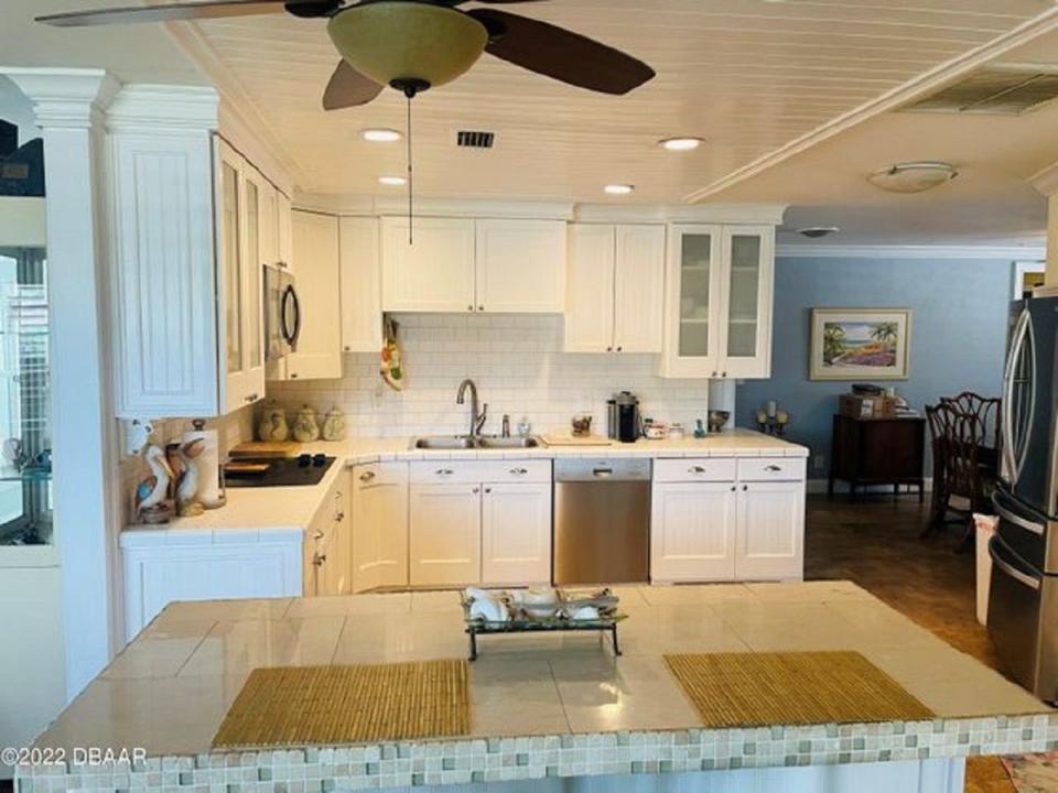 The large light-and-bright updated kitchen has plenty of cabinets and counter space.