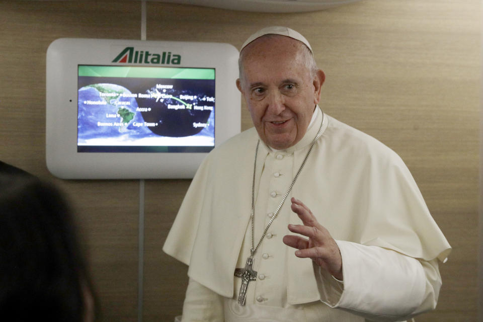 Pope Francis greets the journalists aboard the papal plane heading to Bangkok on the occasion of the pontiff eight days pastoral trip to Thailand and Japan, Tuesday, Nov. 19, 2019. (AP Photo/Gregorio Borgia, Pool)