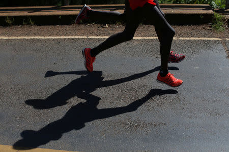 Athletes run on a road during a half marathon near the town of Eldoret in western Kenya, March 20, 2016. REUTERS/Siegfried Modola