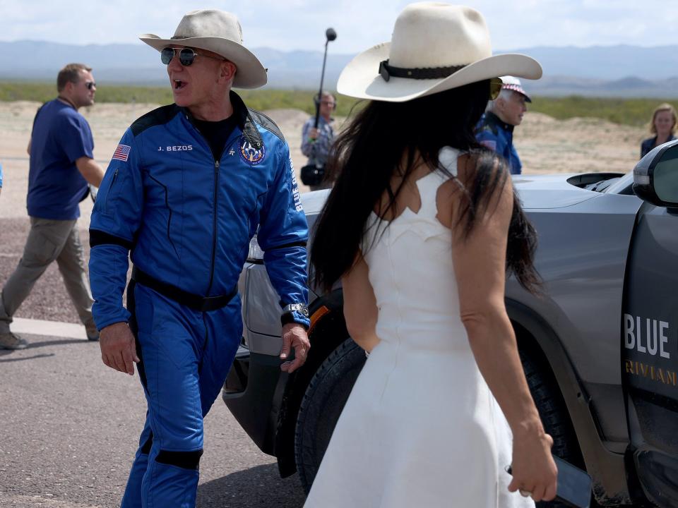 Jeff Bezos walks with Lauren Sanchez ahead of Blue Origin spaceflight