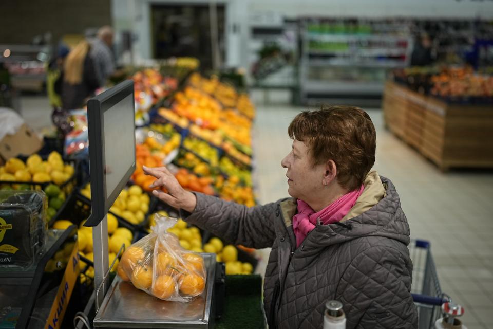People buy fruits at a hypermarket in Moscow, Russia, on Nov. 3, 2023. The shelves at Moscow supermarkets are full of fruit and vegetables, cheese and meat. But many of the shoppers look at the selection with dismay as inflation makes their wallets feel empty. (AP Photo)