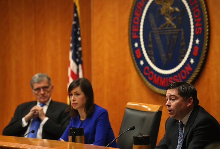 Federal Communications Commission Chairman Tom Wheeler (L), Commissioner Jessica Rosenworcel, and Commissioner Michael ORielly voting on Net Neutrality at the FCC headquarters February 26, 2015, in Washington, DC