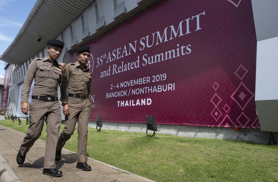 In this Tuesday, Oct. 29, 2019. Thai policemen walk in front of a banner welcoming Association of Southeast Asian Nations at the venue of The 35th annual Association of Southeast Asian Nations (ASEAN) in Nonthaburi province, Thailand. U.S. national security adviser Robert C. O'Brien and Commerce Secretary Wilbur Ross will represent President Donald Trump at two regional summits in Thailand this weekend, the White House announced, a move that would widely be viewed in the region as a snub. (AP Photo/Sakchai Lalit)