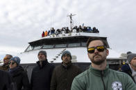 Guests observe the first operating South Fork Wind farm turbine, Thursday, Dec. 7, 2023, 35 miles east of Montauk Point, N.Y., during a tour organized by Orsted. The turbine at the commercial-scale offshore wind farm is producing power for the U.S. electric grid for the first time. (AP Photo/Julia Nikhinson)