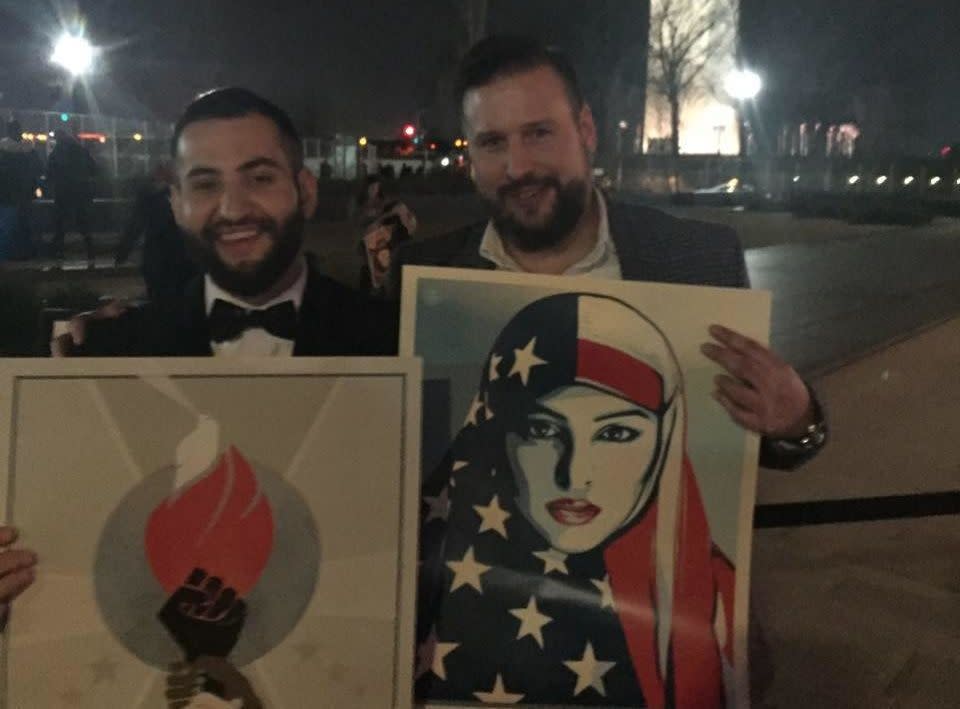 Askaryar and a friend hold posters in front of the Washington Monument. (Photo: Courtesy Bilal Askaryar)