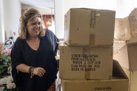 Ginger Pigg moves boxes of shopping bags in the storage room of her gift boutique The Perfect Pigg in Cumming, Ga. on Thursday afternoon, Oct. 22, 2021. The bags should have been delivered in four weeks, but took 14 weeks. (AP Photo/Ben Gray)