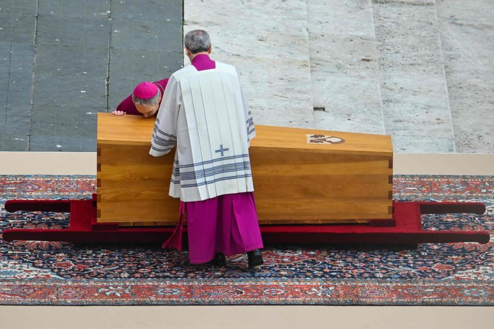 Archbishop Georg Ganswein pays his respect next to the coffin of Pope Emeritus Benedict XVI at the start of his funeral mass at St. Peter's square in the Vatican (AFP via Getty Images)