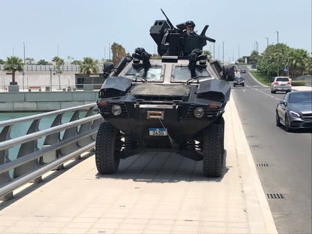 Bahraini armoured vehicle takes up position on bridge leading to Manama’s Four Seasons hotel for first day of U.S.-hosted “Peace to Prosperity” conference, in Manama